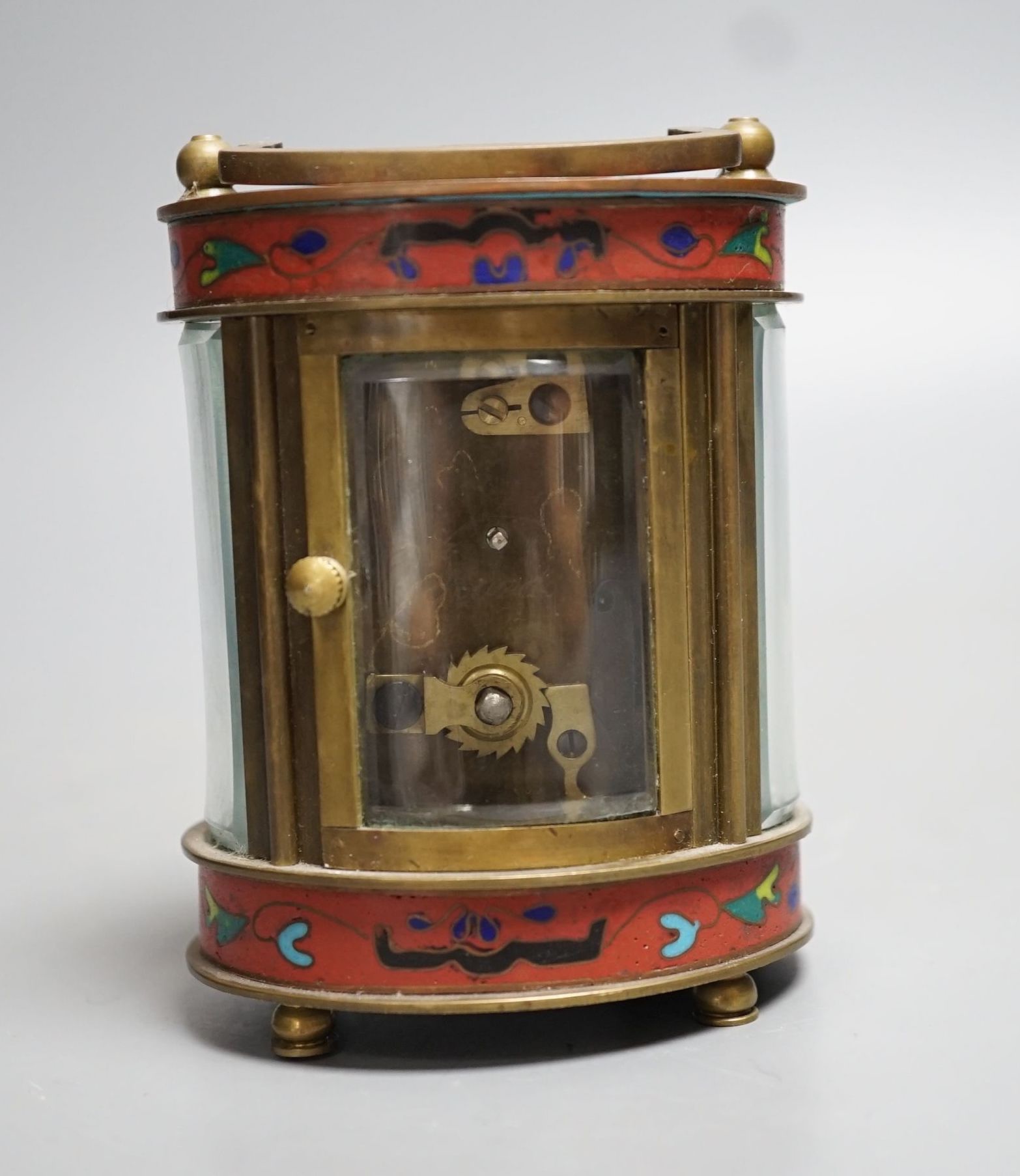 A mignonette oval brass and champleve enamelled timepiece 9cm
